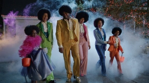 The Johnson family wearing multi-colored suits with blow out hairstyles.
