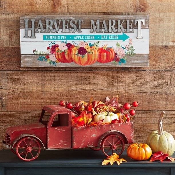 Harvest Market sign with pumpkins and the words &quot;pumpkin pie, apple cider, and hay rides&quot;
