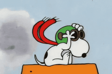 Snoopy yelling in an ace pilot head gear and scarf.