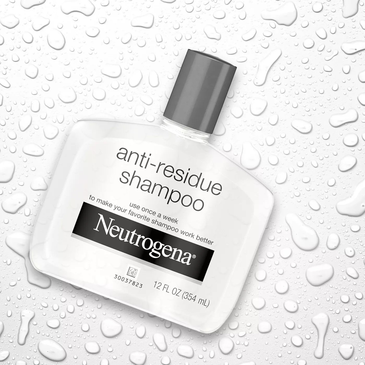 Bottle of Neutrogena anti-residue shampoo surrounded by water droplets