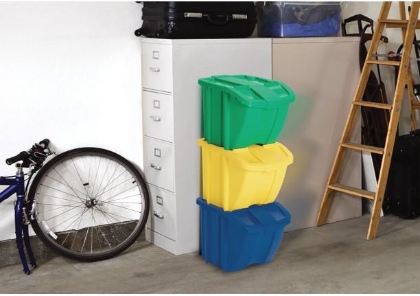 three bins stacked on top of each other in a garage