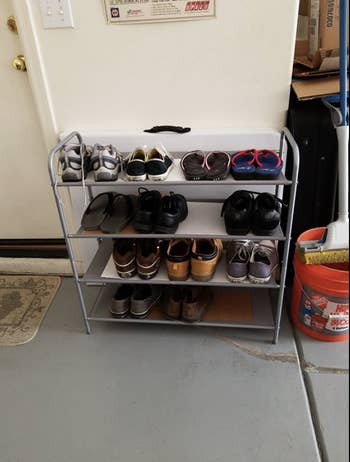shoe rack looking tidy in garage beside of door to house