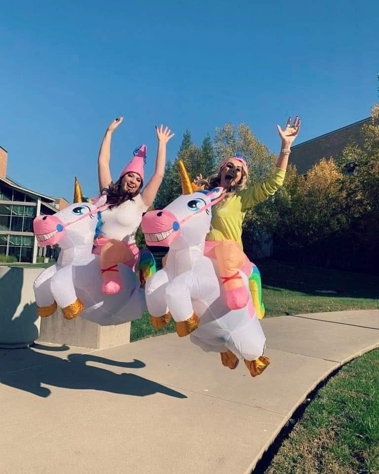 Reviewer&#x27;s photo of two people wearing the unicorn costume