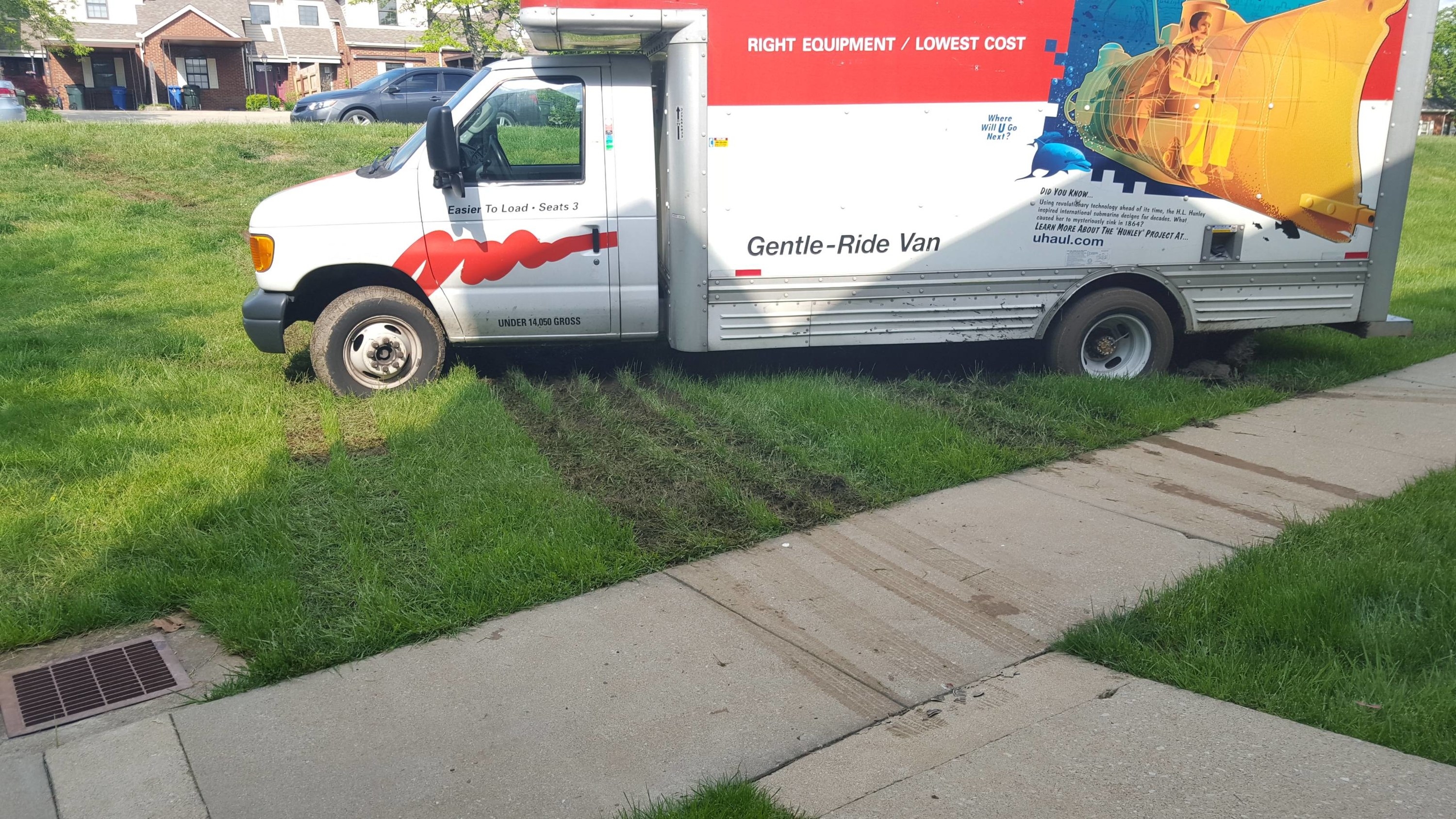 a U-Haul stuck in the grass on a lawn
