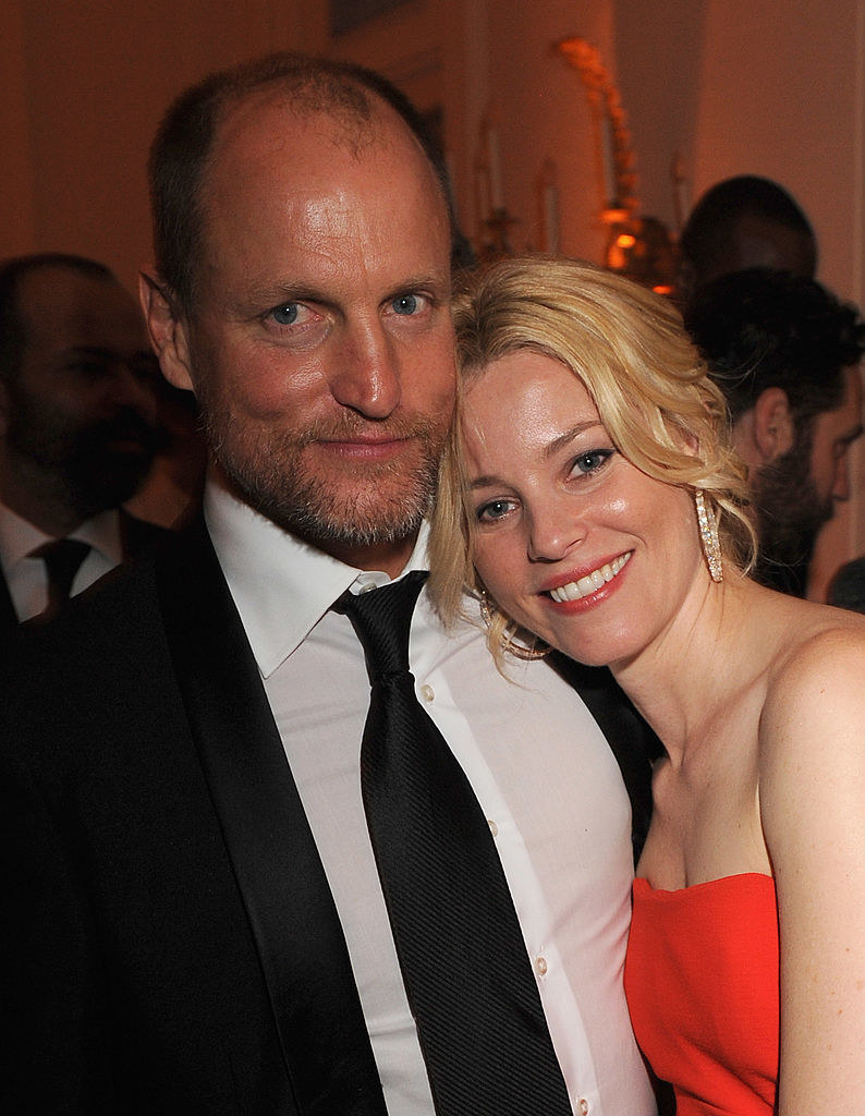 Woody Harrelson and Elizabeth Banks hugging each other at an event