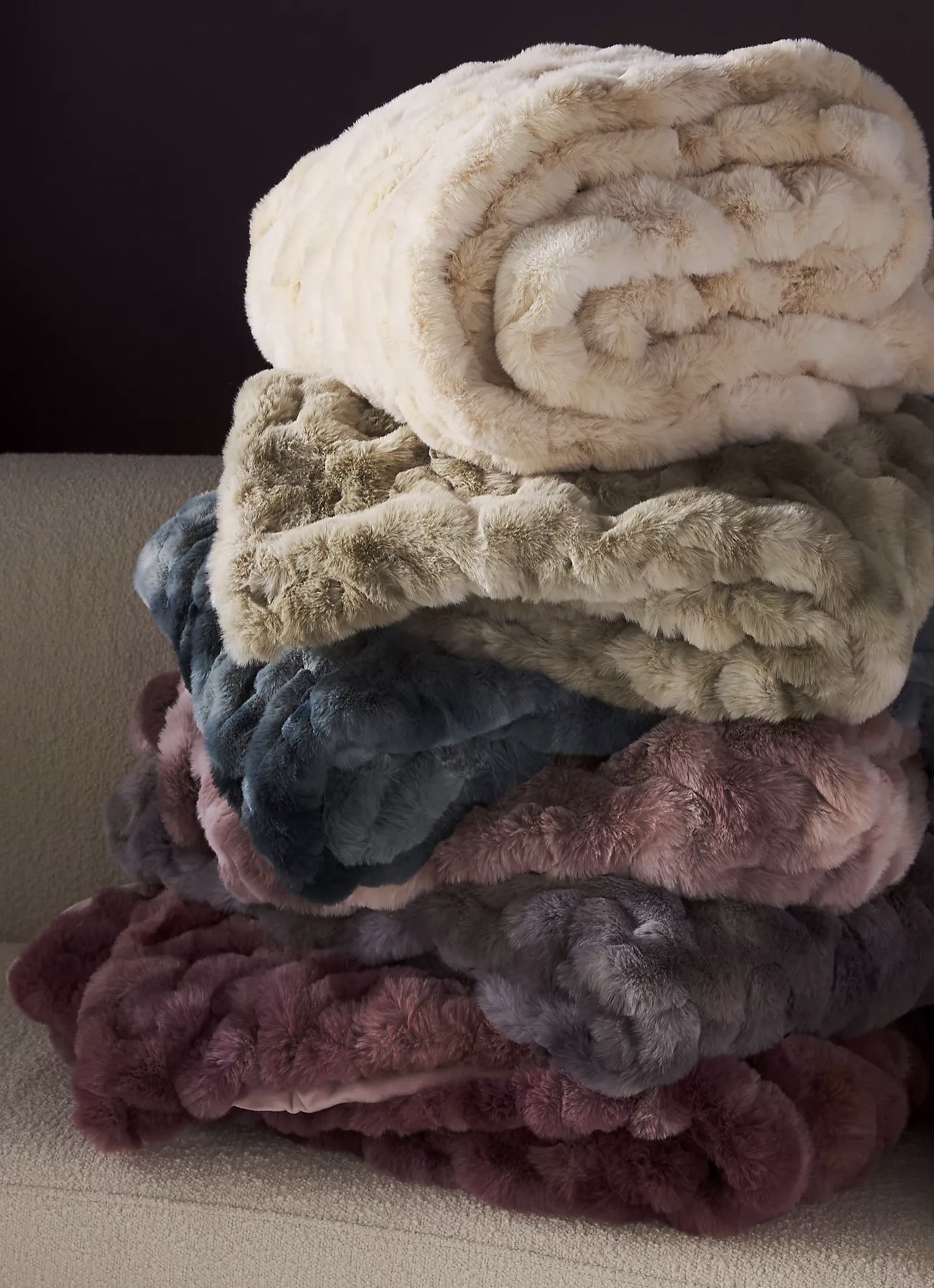 The faux fur blanket in a bunch of different colors