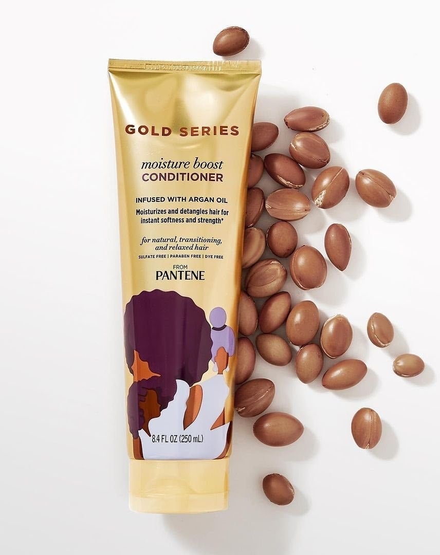 A tube of conditioner  with argan nuts around it
