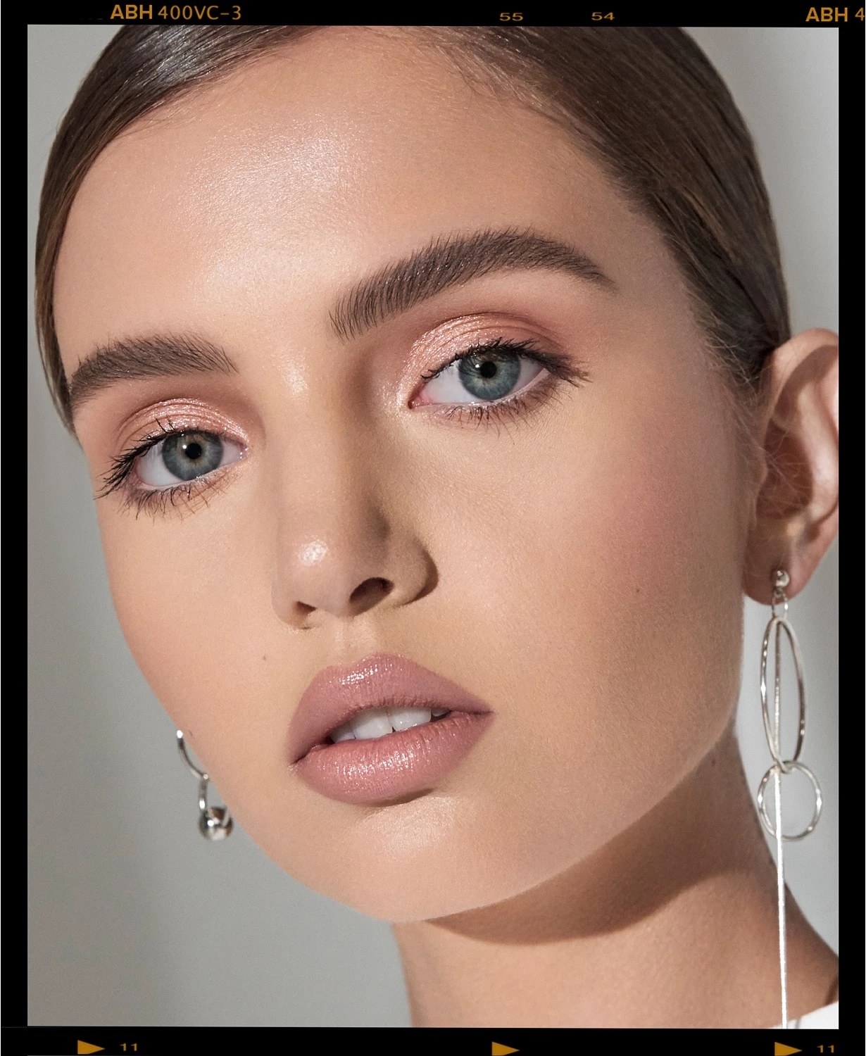 Model wearing eyebrow gel and full face of neutral makeup