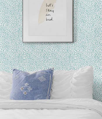 Blue speckled wallpaper in a bedroom