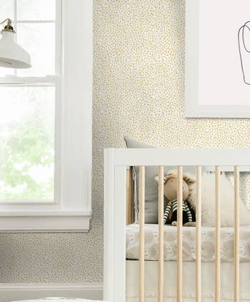 Yellow speckled wallpaper in a nursery