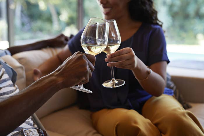 Two people enjoy a glass of wine on a date