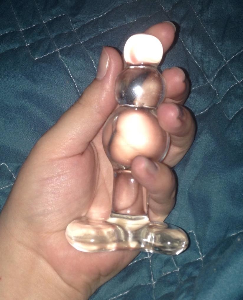 Reviewer holding glass butt plug