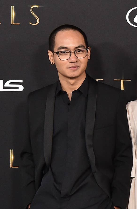 Max wore a dark suit, eyeglasses, and dark studded earrings at the premiere