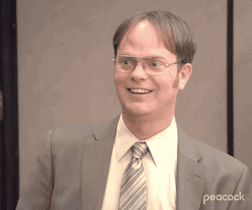 The camera zooms in on a smiling Dwight Schrute as he nods his head