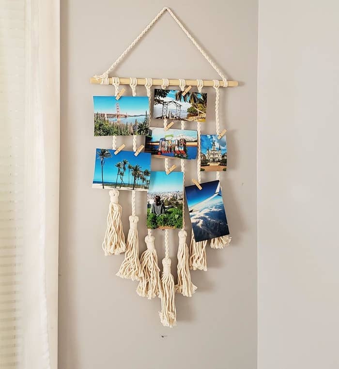 Reviewer photo of the white macrame photo display hanging on the wall