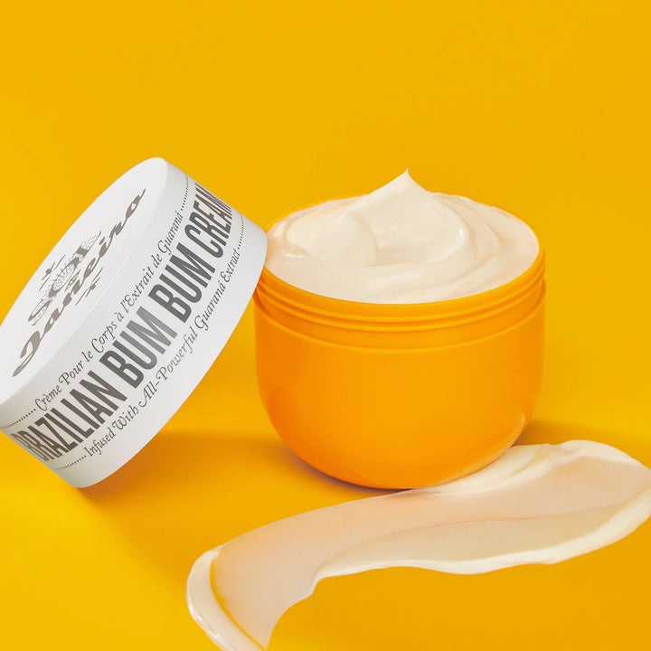 Open tub of Brazilian bum bum cream with a product swatch