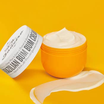 Open tub of Brazilian bum bum cream with a product swatch