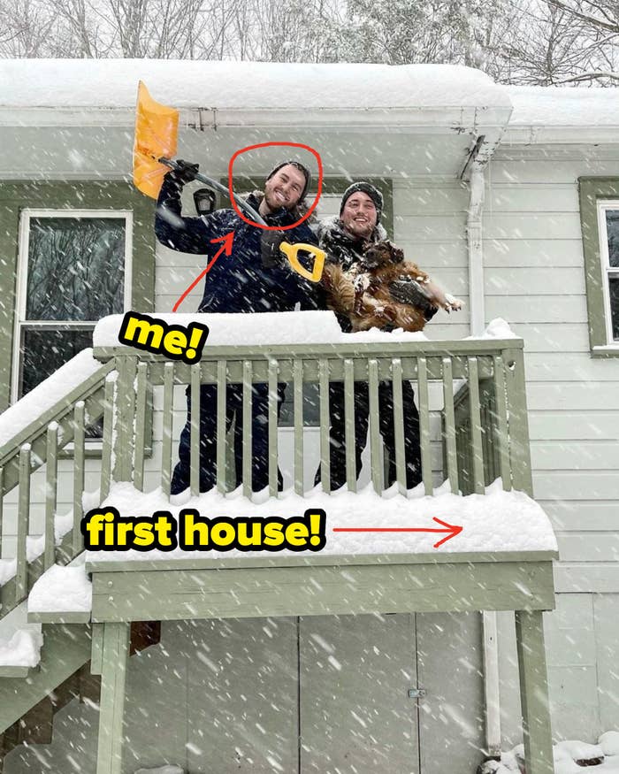 Author standing in front of new house in the middle of a snowstorm.