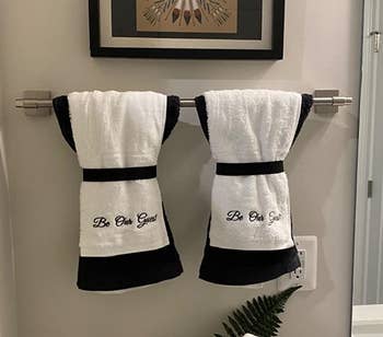 Reviewer photo of the Be Our Guest hand towels arranged on a towel rack