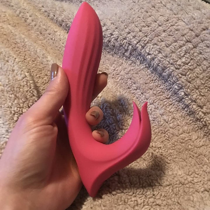 Reviewer holding pink rabbit vibrator