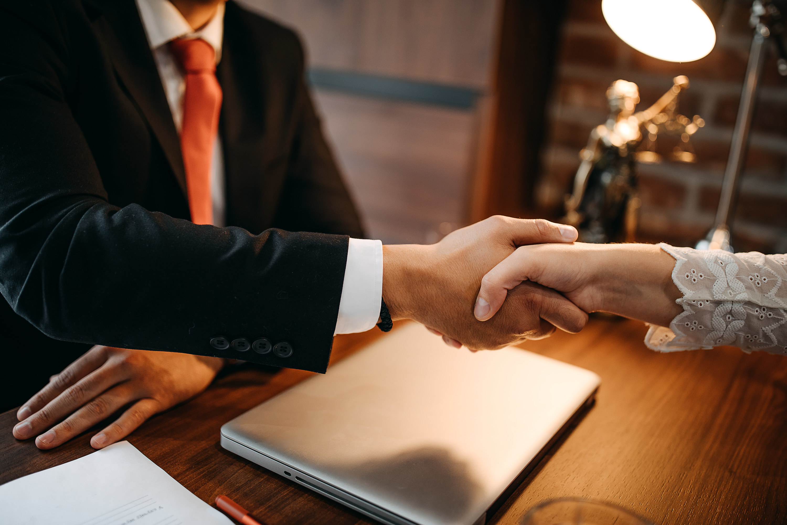 Buyer shaking hands with attorney in an office setting