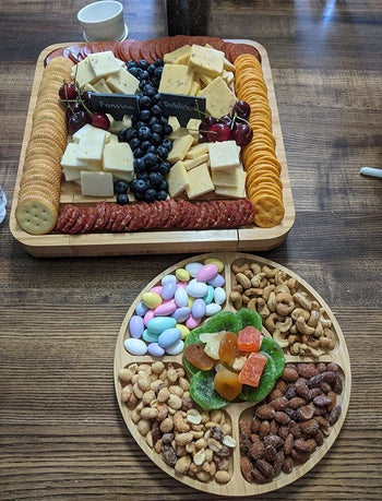 Reviewer photo of the charcuterie board and round tray filled with snacks
