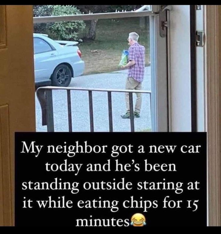 man eating a bag of chips while admiring his new car