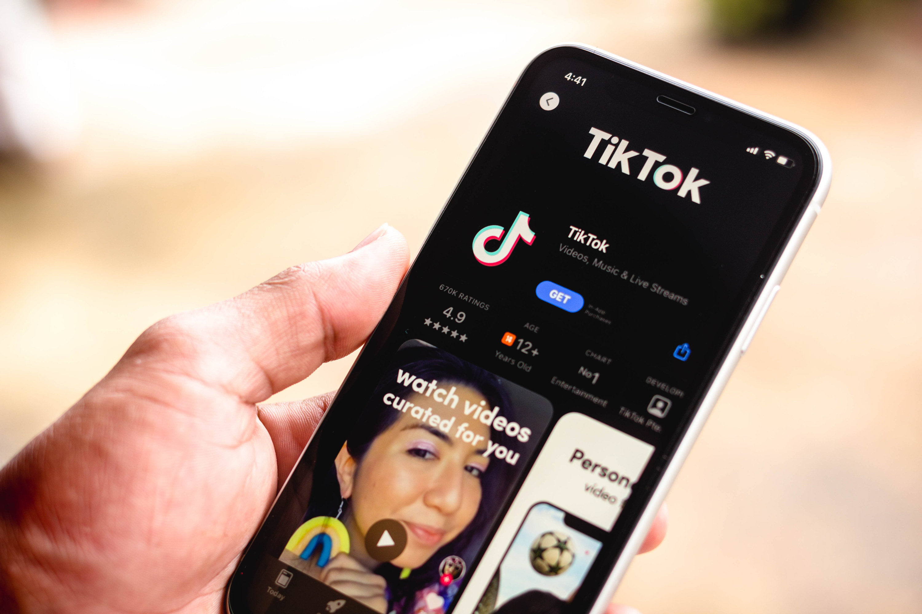 A person looking at the TikTok app on their phone