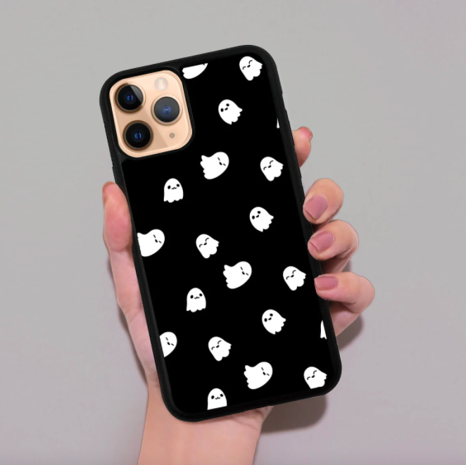 someone holding up their phone; it has a case on it printed with cute and tiny ghosts