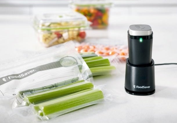The vacuum sealer charging next to air-tight sealed celery