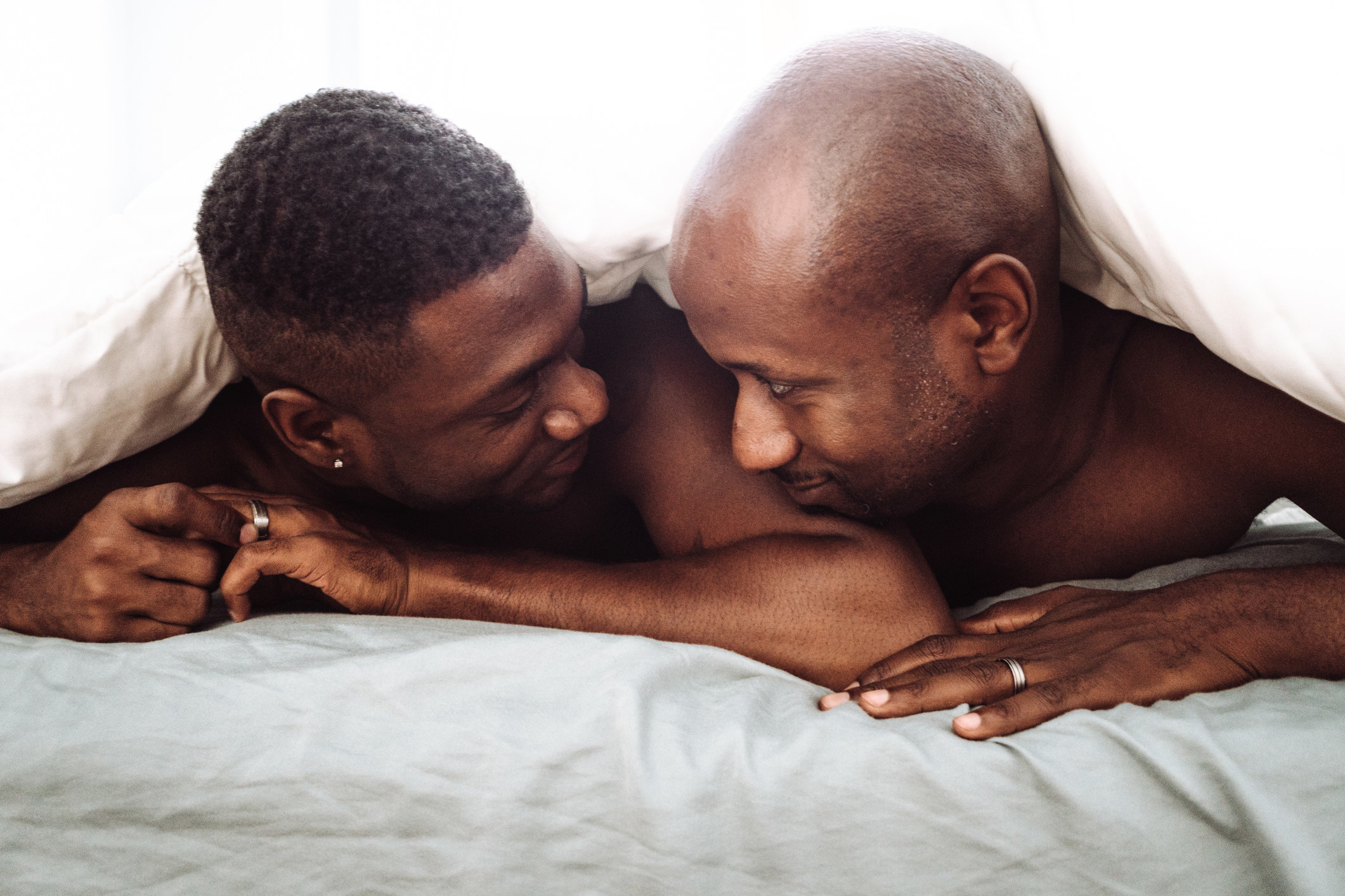 A same-sex couple in bed together