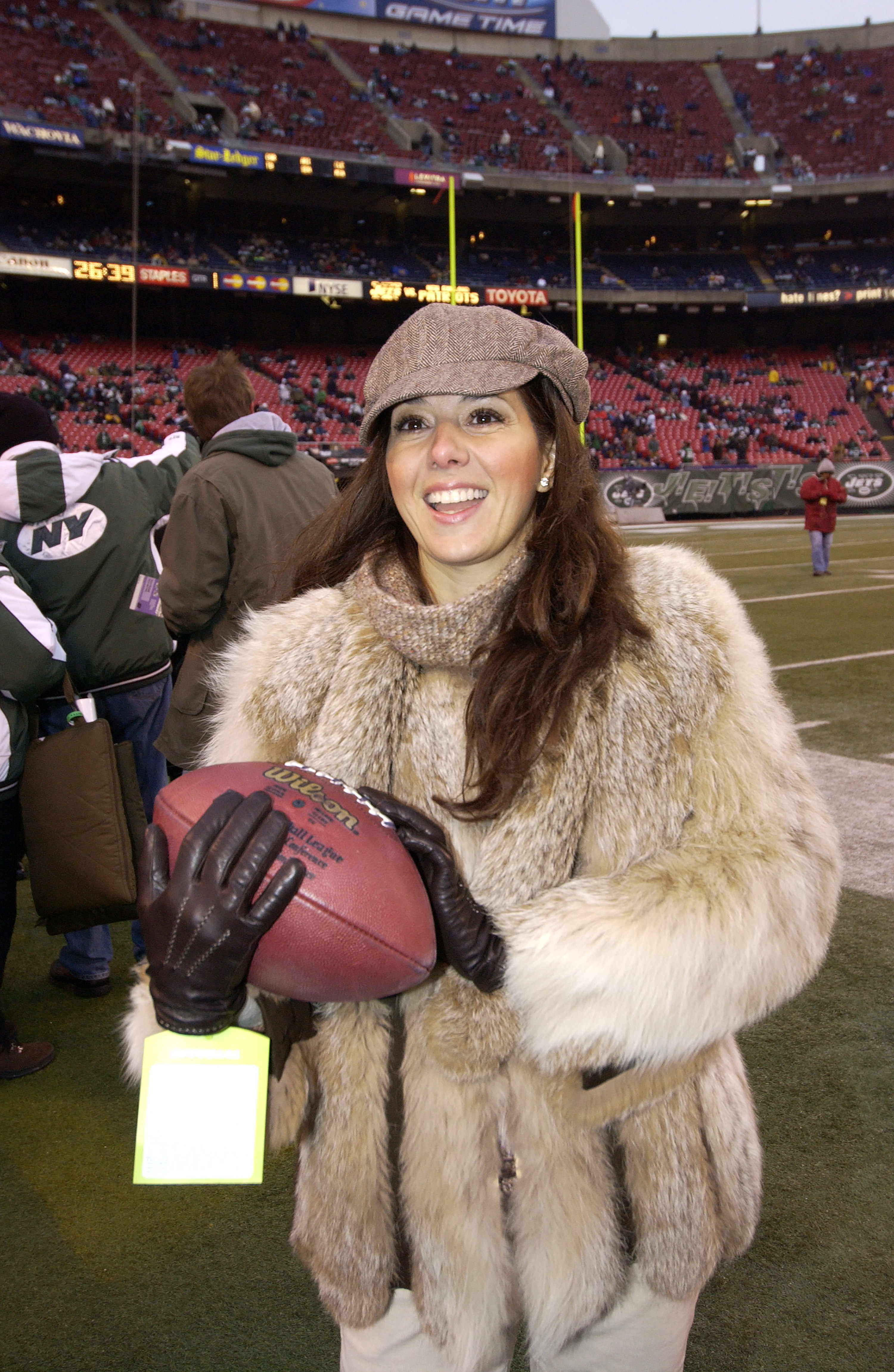 Holding a football and wearing a fur