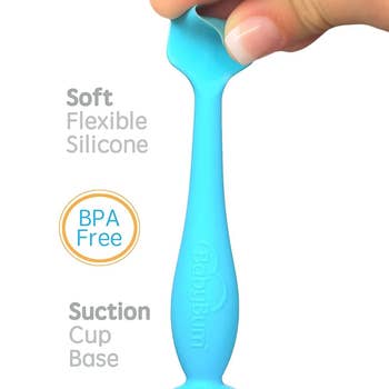 Blue silicone applicator with a person's presses finger pressing on the tip to show that it is soft and flexible