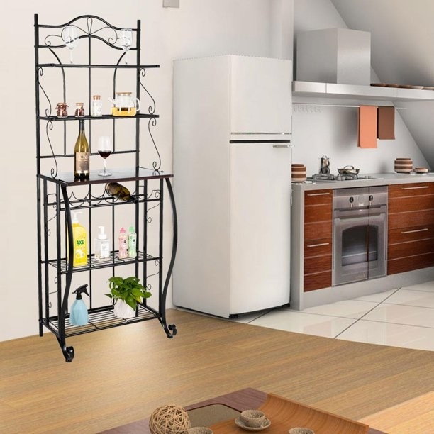The black baker&#x27;s rack used for storage and organization in the kitchen