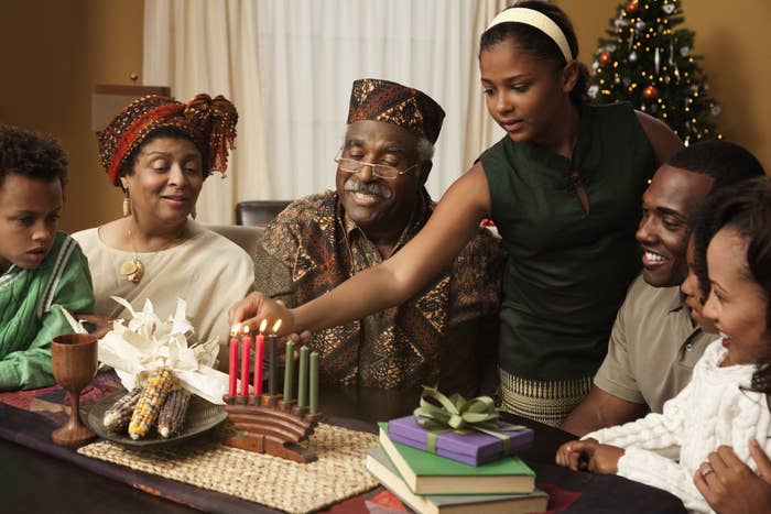 A family lighting Kwanzaa candles