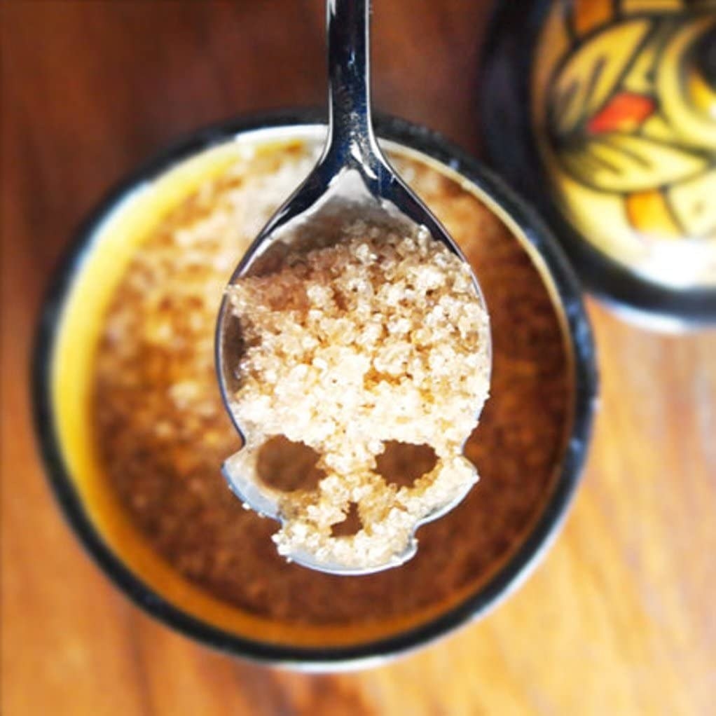 a close up of a sugar spoon shaped like a skull