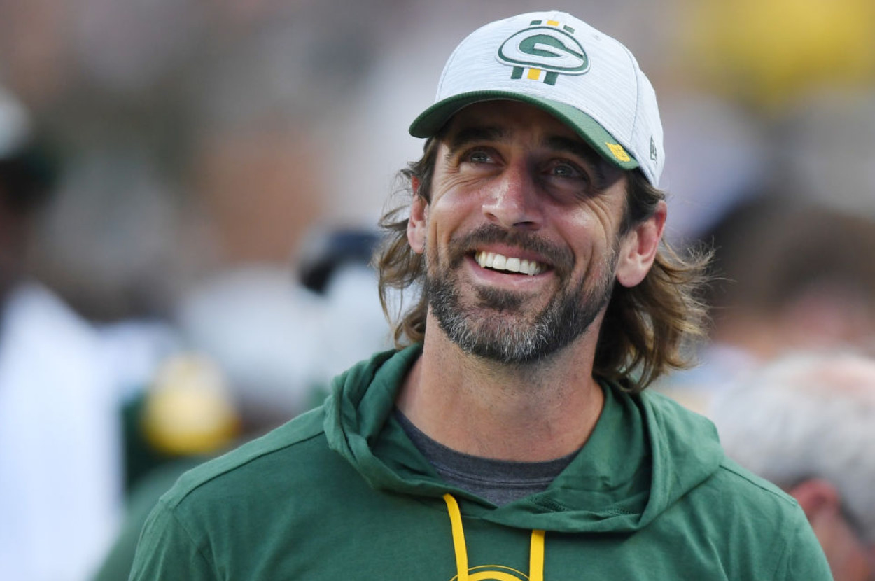 Aaron Rodgers smiling in a Greenbay Packers hat