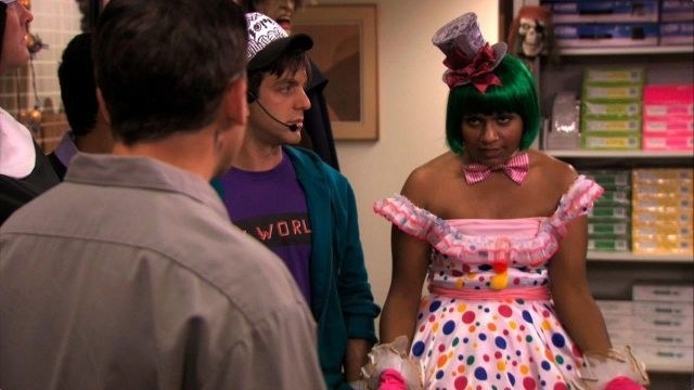 Kelly Kapoor in a green wig and polka dot dress.
