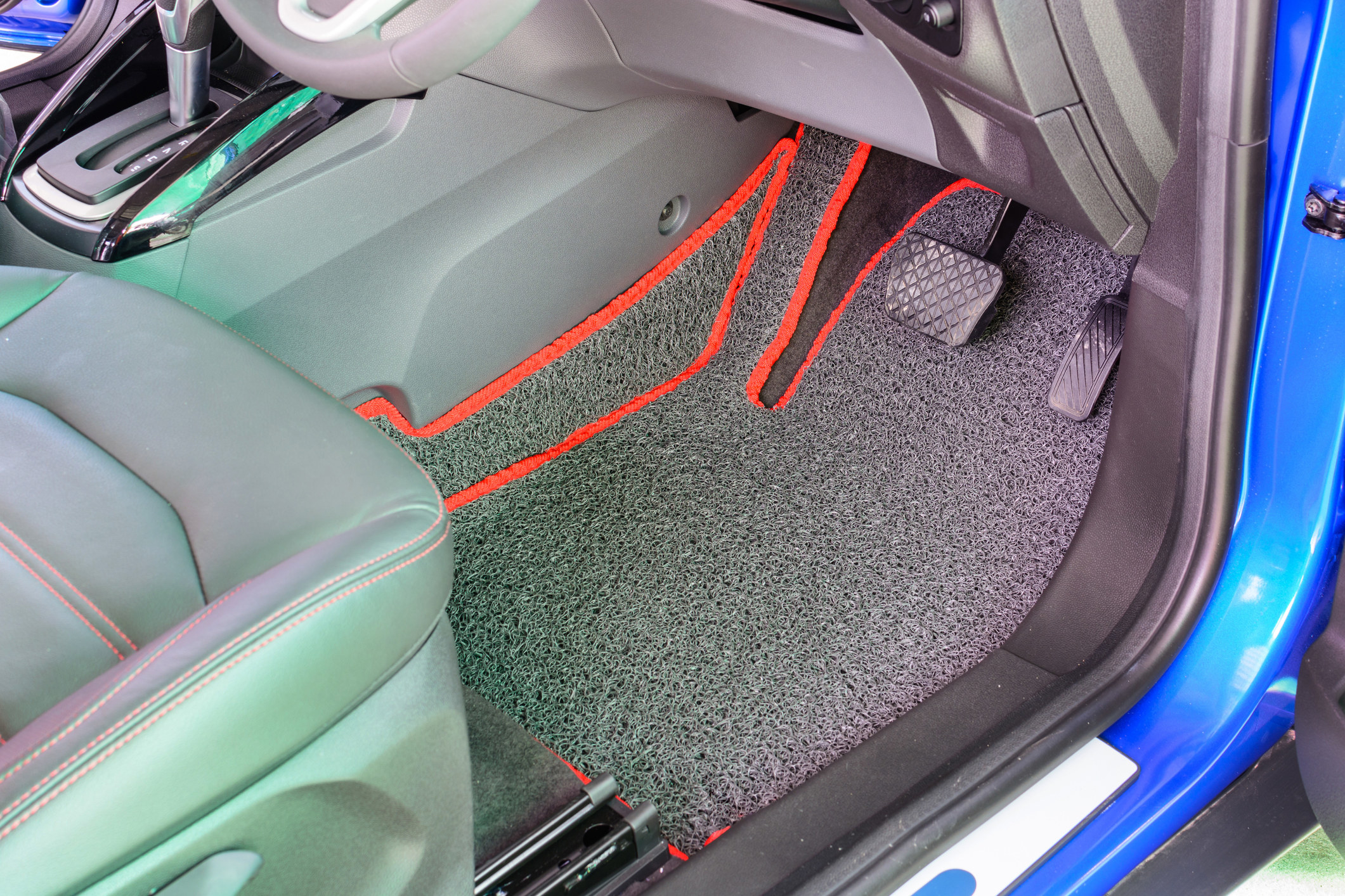 Clean, vinyl floor mats in a car.