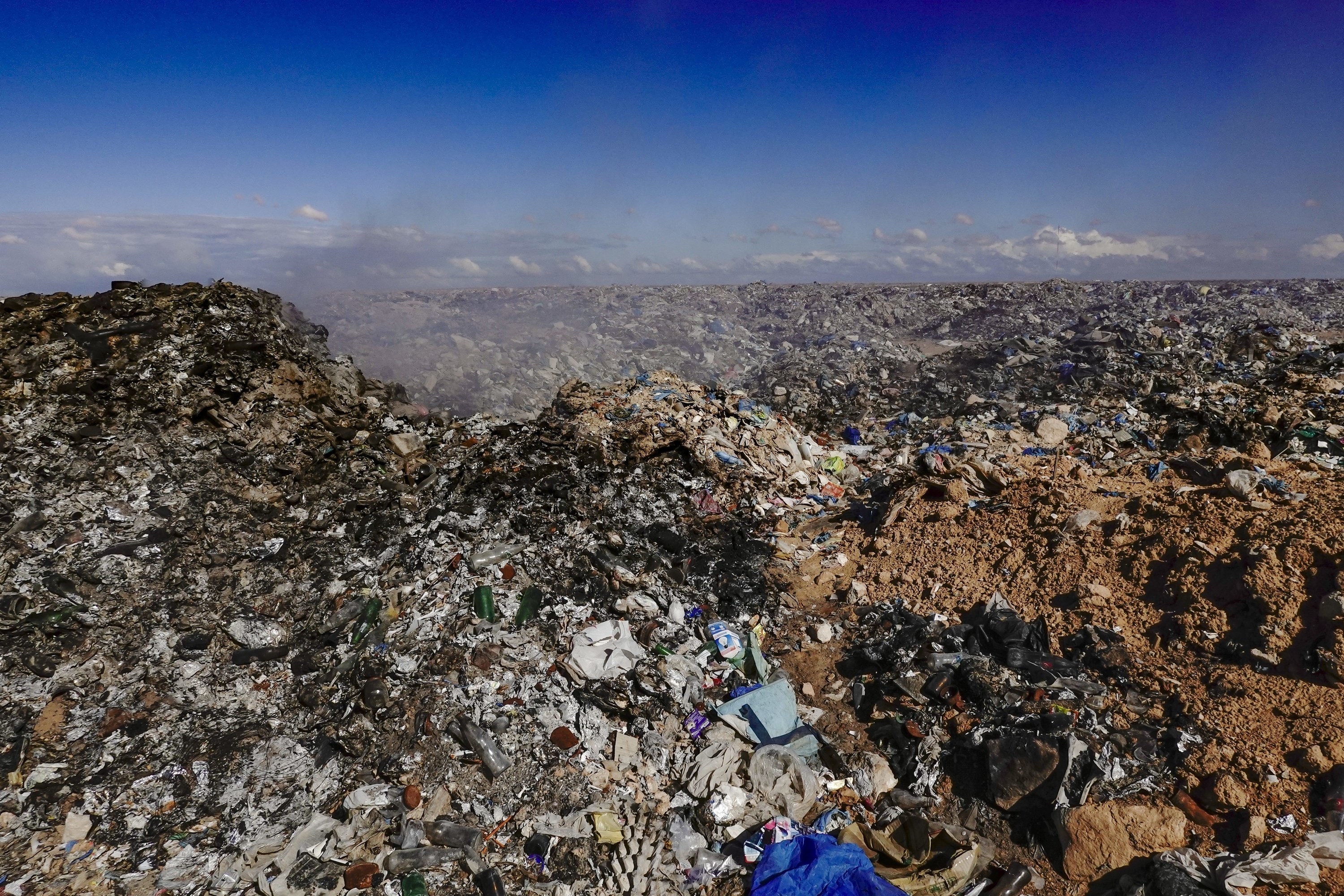 Landscape in Egypt shows mountains of trash in the distance