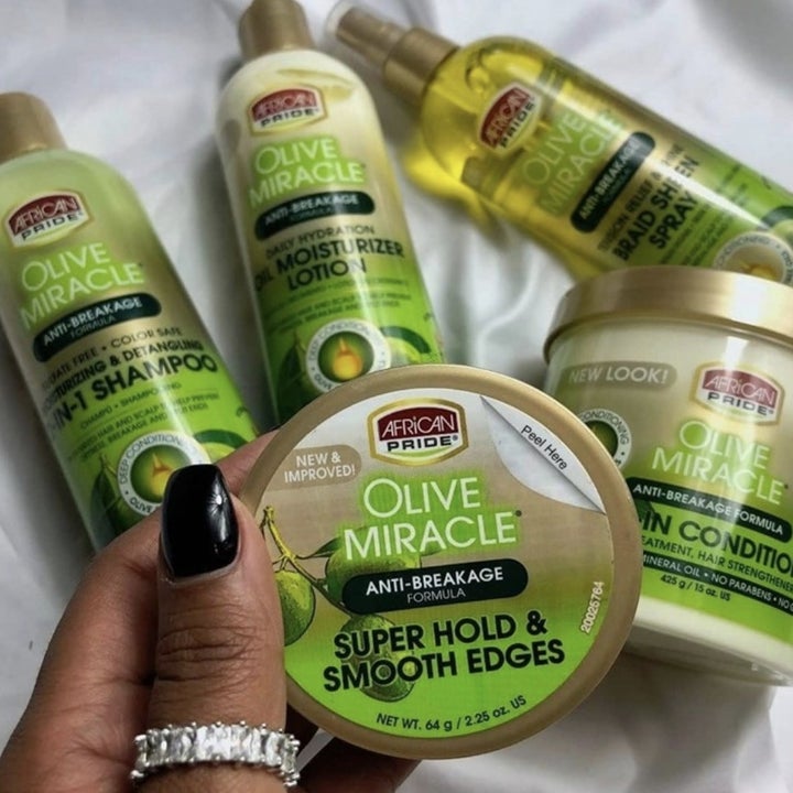 A person holding a jar of edge control gel