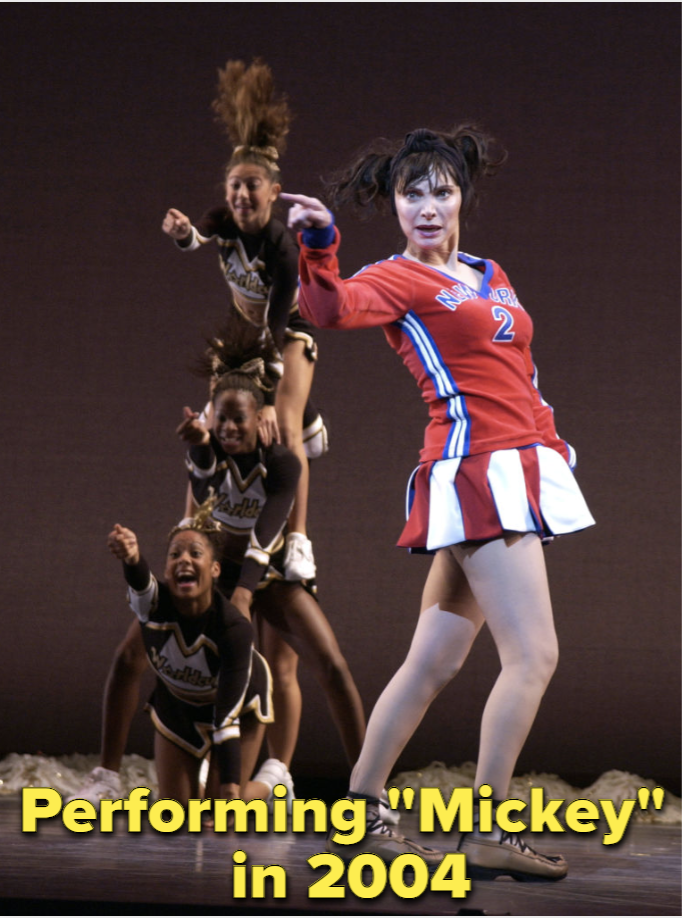 Basil performing Mickey onstage in her classic cheerleader garb in 2004