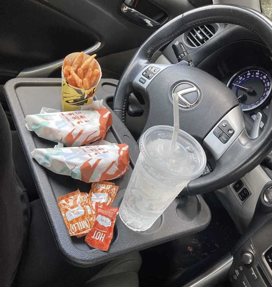 reviewer photo showing Taco Bell on the car tray attached tot their steering wheel