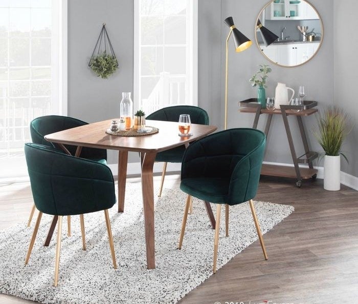 set of four green chairs at table