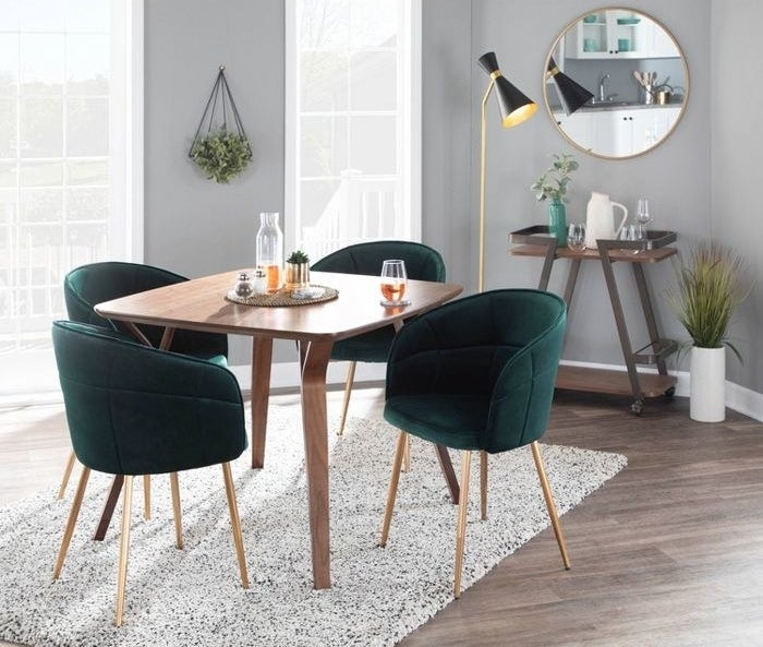 set of four green chairs at table