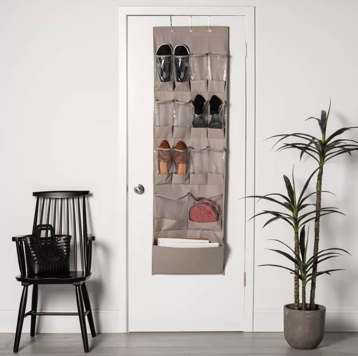 the over-door organizer holding papers, a purse, and shoes