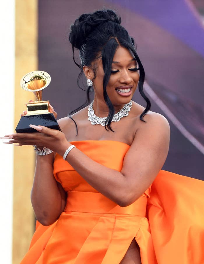 Megan holding up her Grammy award