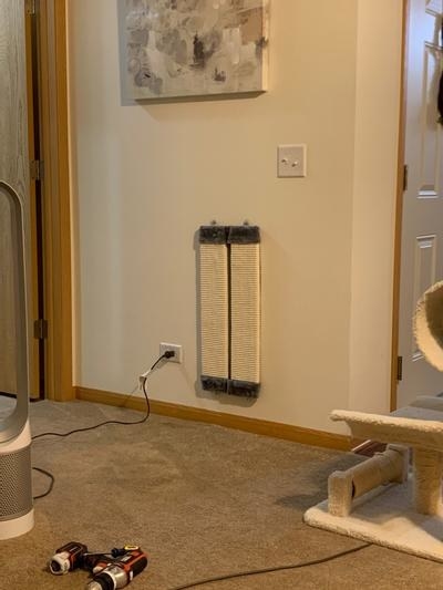 The gray cat scratcher mounted on a reviewer&#x27;s wall