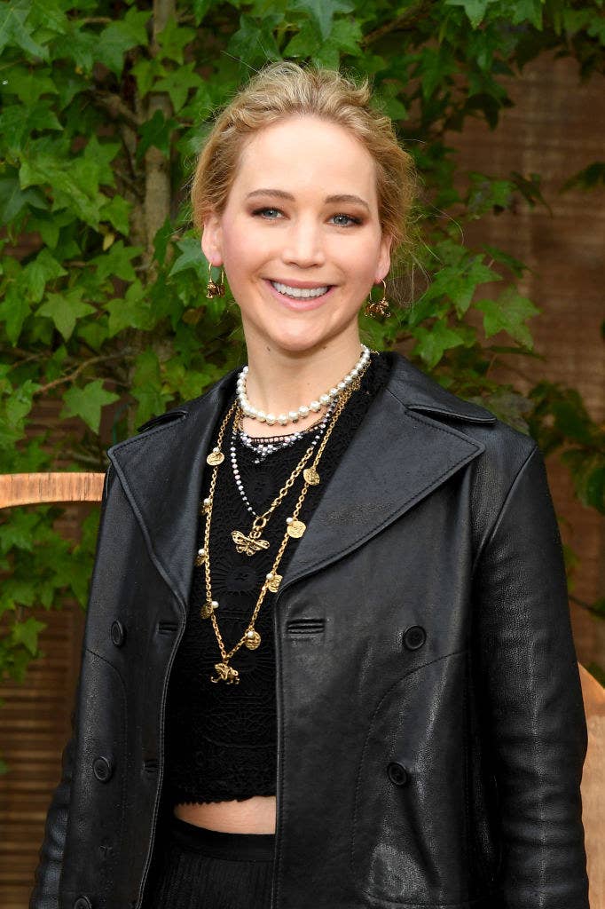 Jennifer wearing a dark top, pants, and a leather jacket at an event