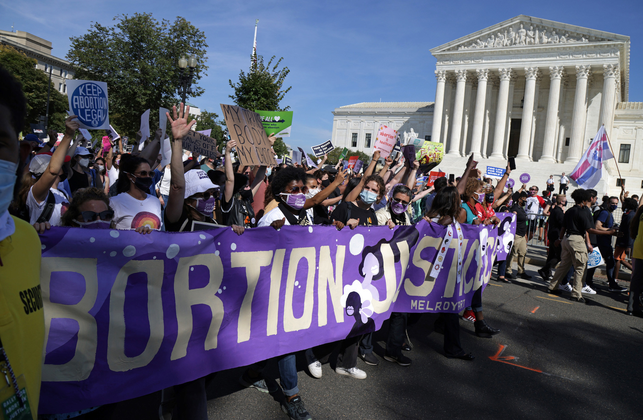 Protesters carry a banner saying &quot;Abortion Justice&quot;